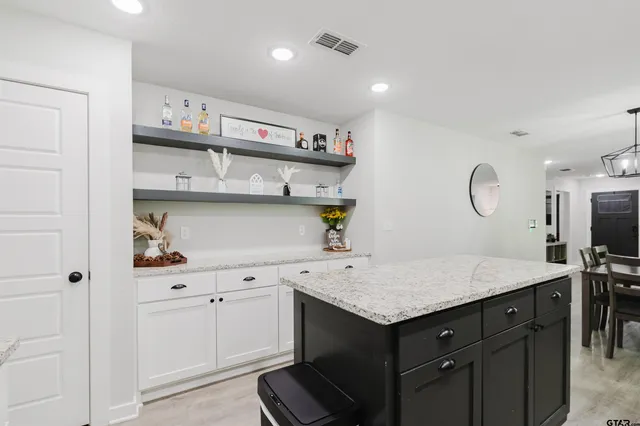 a kitchen with a sink cabinets and wooden floor