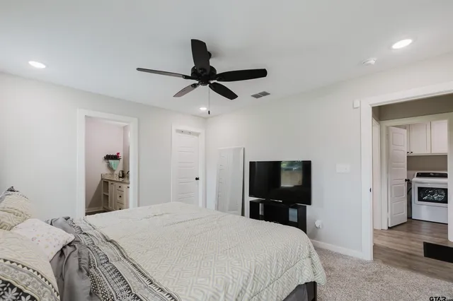 a bedroom with a bed and a ceiling fan