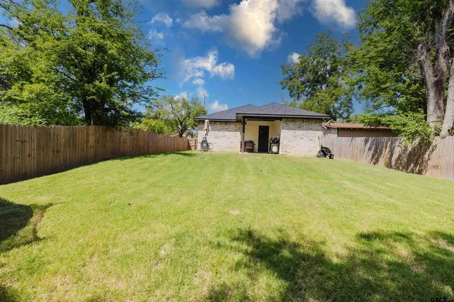a view of a house with a yard and garage