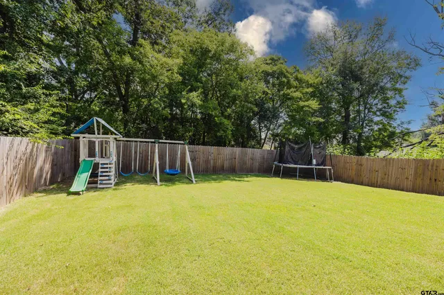 a house view with a backyard space