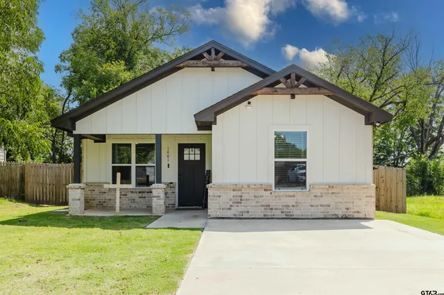 a front view of a house with a yard and porch