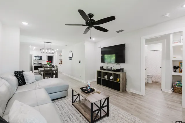 a living room with furniture a table and a flat screen tv