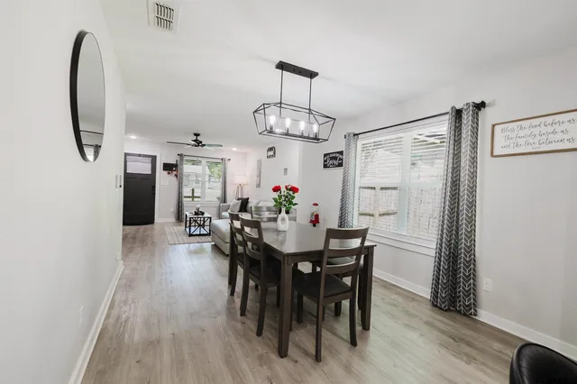 a view of a dining room with furniture and wooden floor