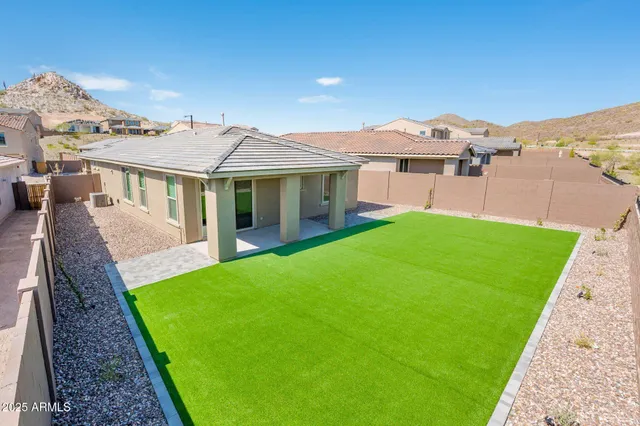 a view of a house with a yard and deck