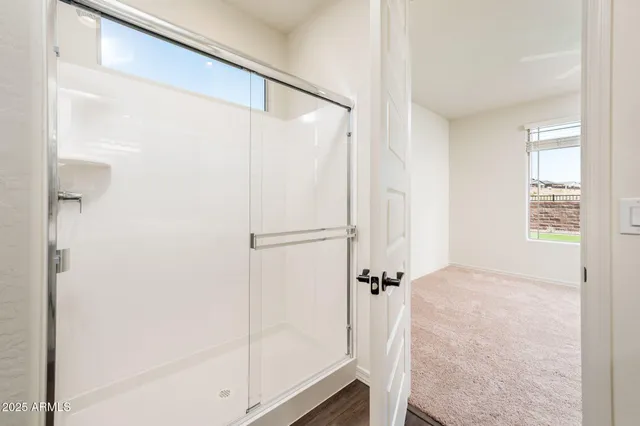a bathroom with a glass shower door