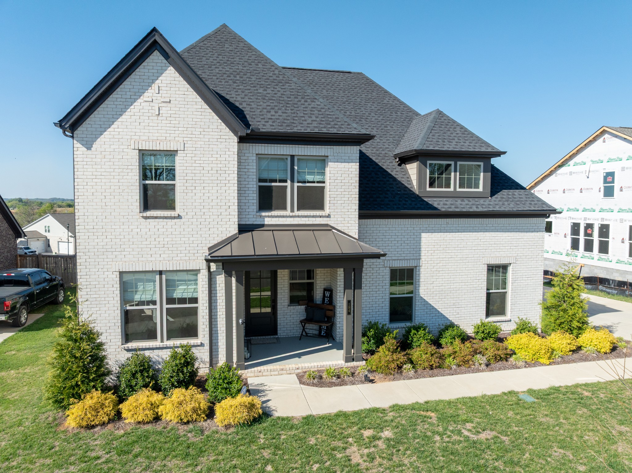 a front view of a house with a yard and porch