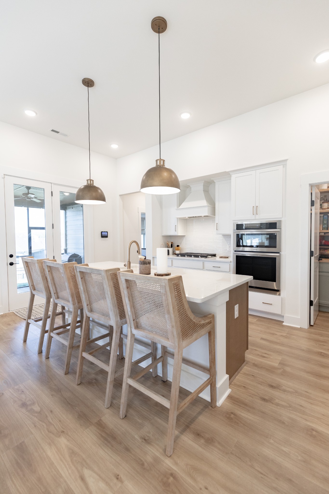 194 Phillips Bend Spring Hill Spring Hill, TN 37174 - Photo 26 of 70 a kitchen with stainless steel appliances kitchen island granite countertop a table chairs and a wooden floor