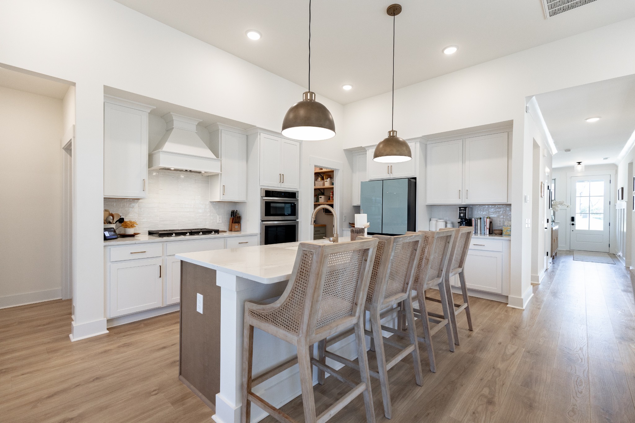 194 Phillips Bend Spring Hill Spring Hill, TN 37174 - Photo 27 of 70 a kitchen with stainless steel appliances kitchen island granite countertop a wooden floor and white cabinets