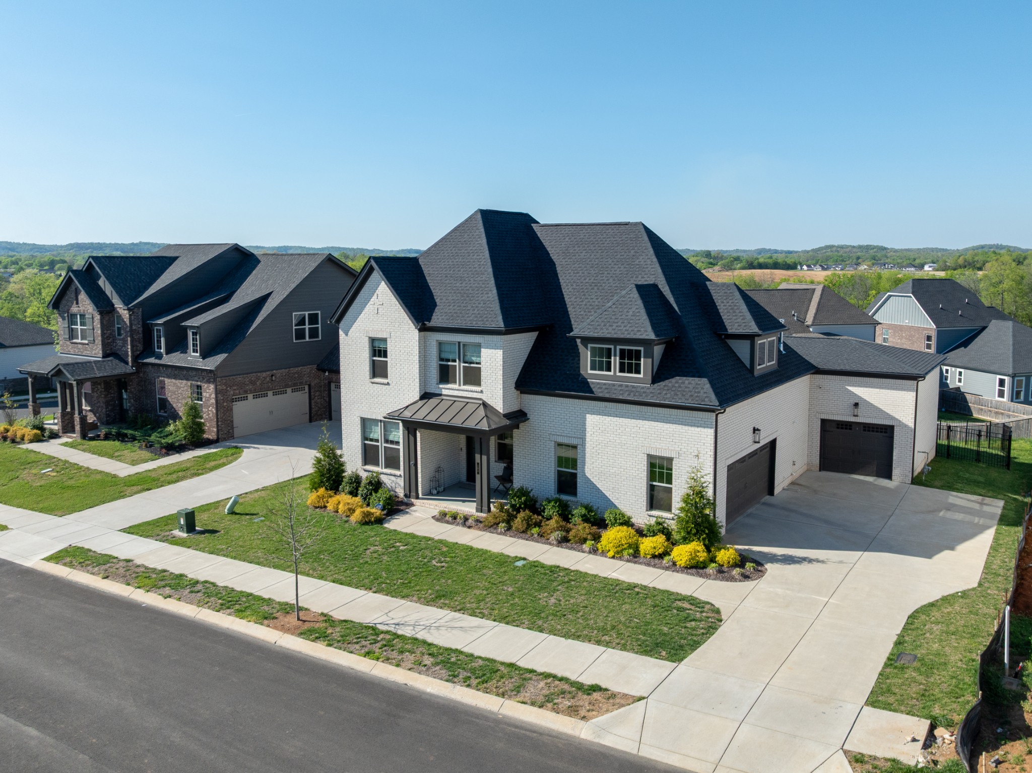 194 Phillips Bend Spring Hill Spring Hill, TN 37174 - Photo 4 of 70 a front view of residential houses with yard and mountain view in back
