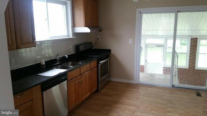 3210 Lynch Road Baltimore, MD 21219 - Photo 3 of 15 a kitchen with granite countertop a sink and a stove