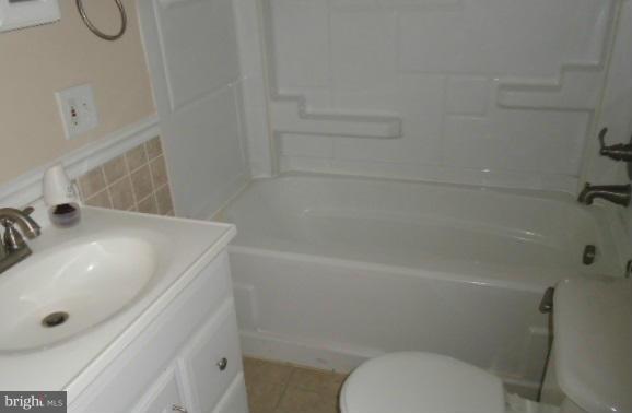 3210 Lynch Road Baltimore, MD 21219 - Photo 7 of 15 a bathroom with a sink a toilet and shower