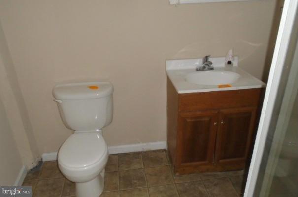 3210 Lynch Road Baltimore, MD 21219 - Photo 8 of 15 a bathroom with a sink toilet and mirror