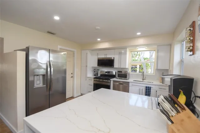 a kitchen with a refrigerator stove and sink