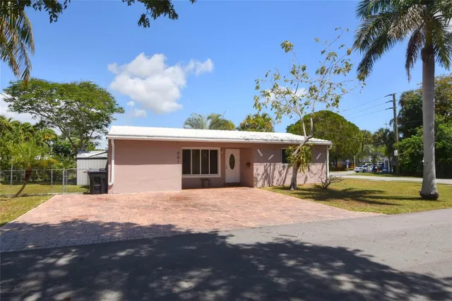 a view of a house with a yard and potted plants