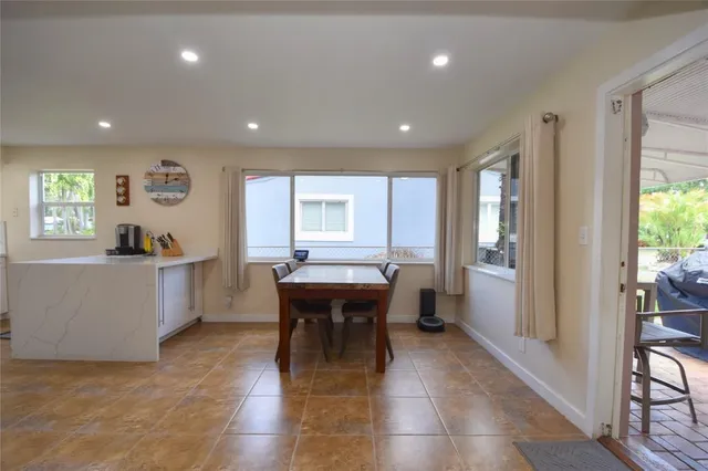 a view of a kitchen with dining area a sink and wooden floor
