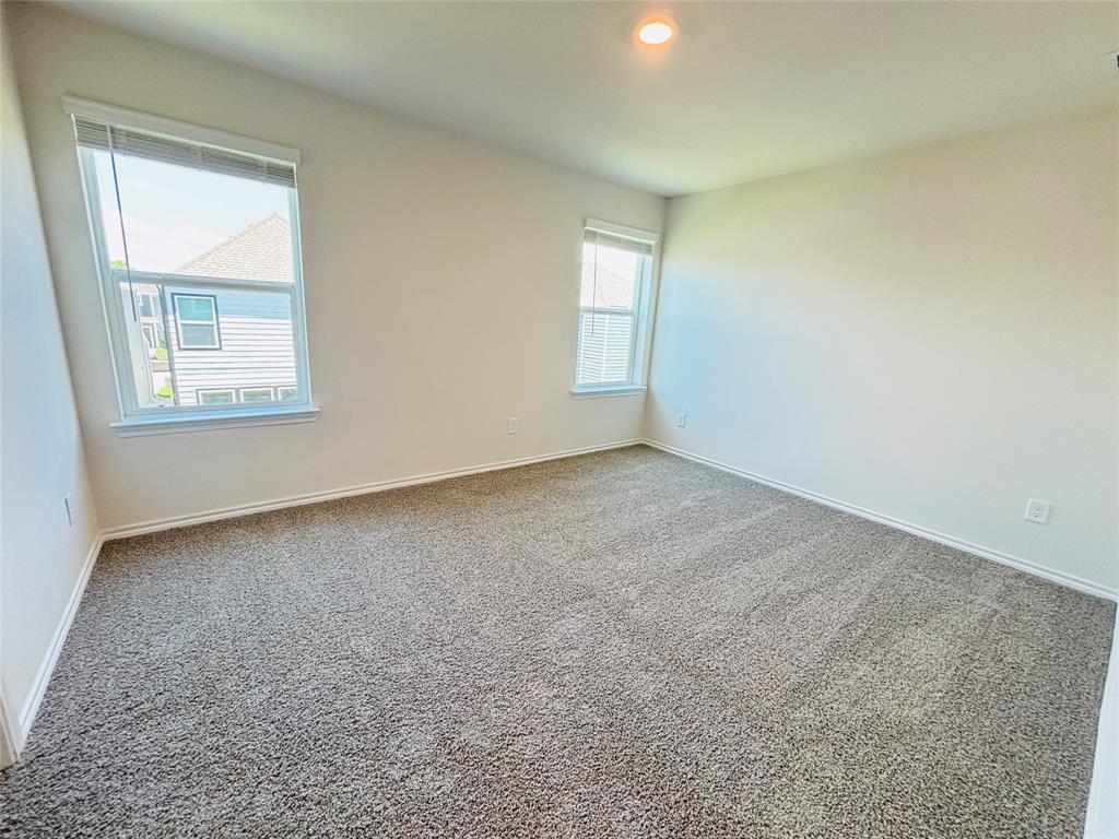 120 Redwood Road Princeton, TX 75407 - Photo 13 of 24 Spacious room featuring neutral carpeting and light-toned walls
