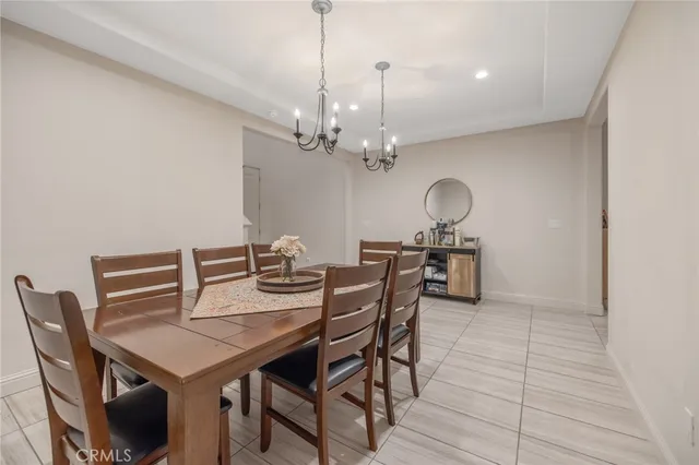 a view of a dining room with furniture and chandelier