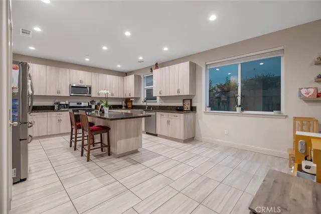 a kitchen with stainless steel appliances granite countertop a stove top oven a sink a counter top space and cabinets