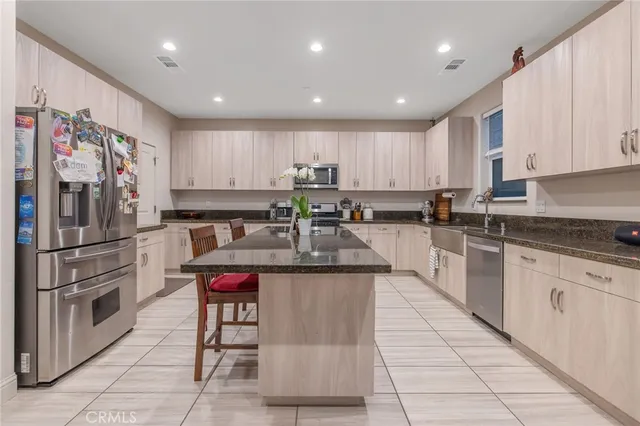 a kitchen with stainless steel appliances granite countertop a refrigerator sink and cabinets