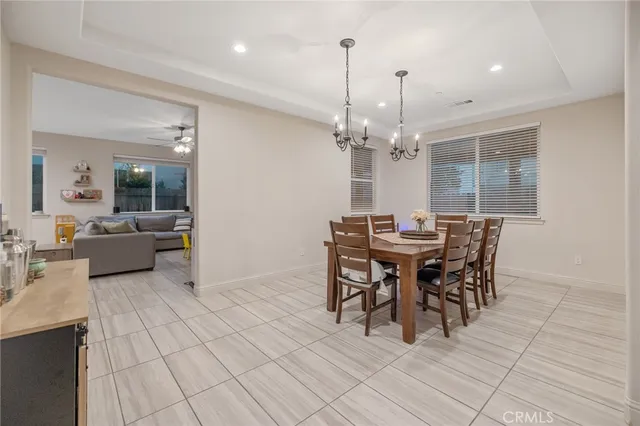 a view of a dining room with furniture and chandelier