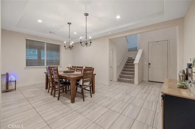 a view of a dining room with furniture and chandelier