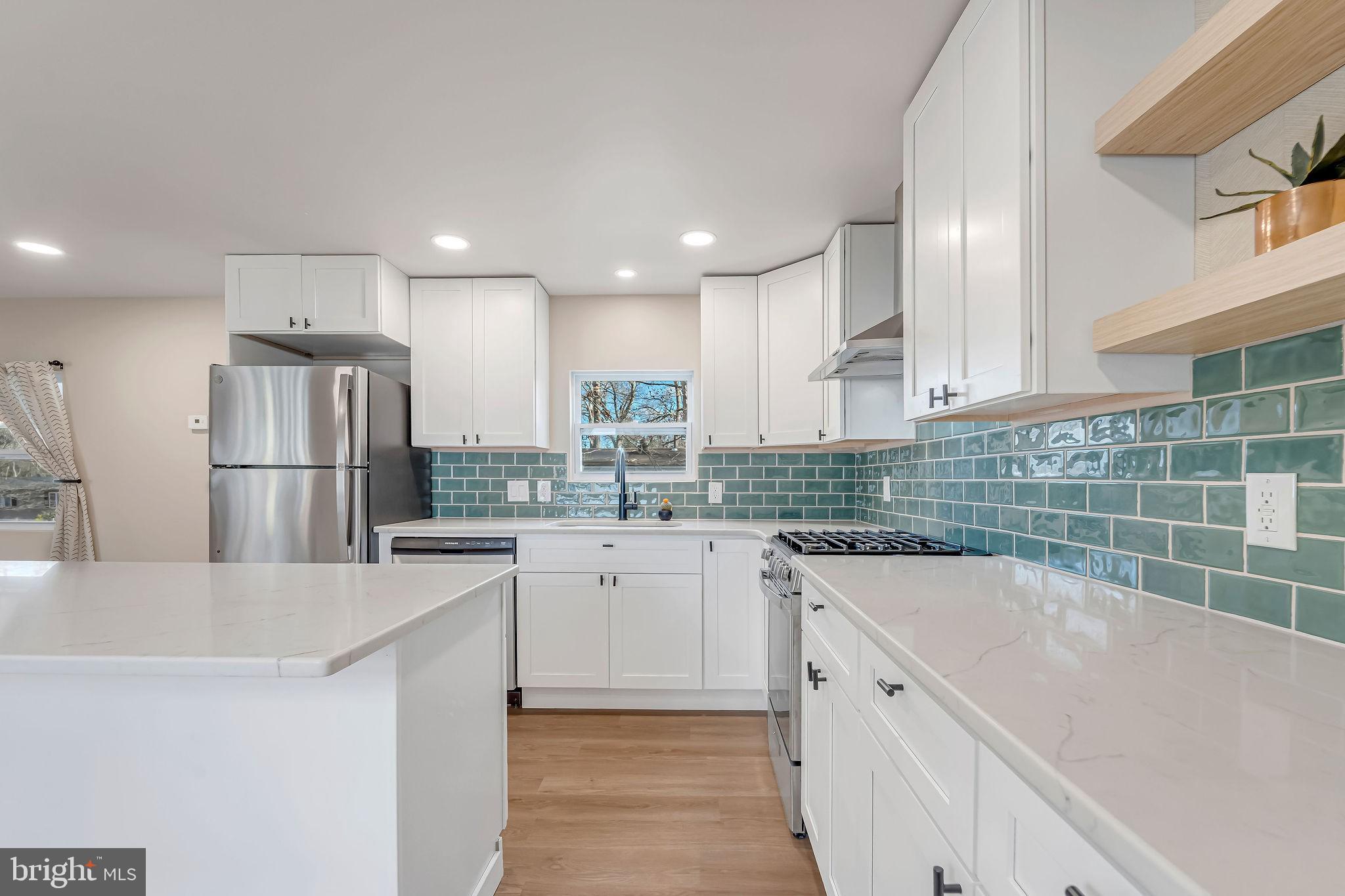 3620 Weymouth Road Browns Mills, NJ 08015 - Photo 15 of 27 a kitchen with a sink a refrigerator and white cabinets