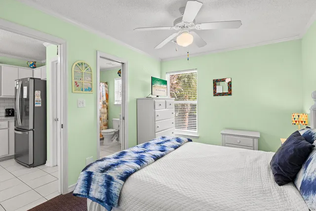 a bedroom with a bed dresser and a window