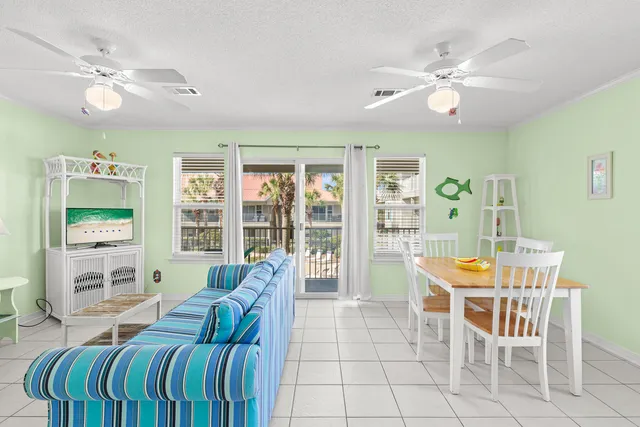 a living room with furniture a large window and kitchen view