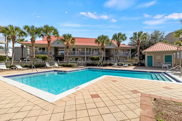 a swimming pool with outdoor seating and yard