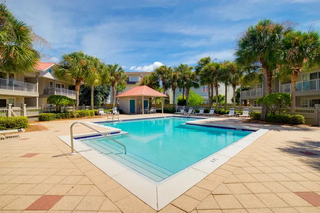 a swimming pool with outdoor seating and yard