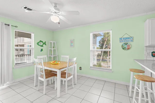 a dining room with furniture a chandelier and window