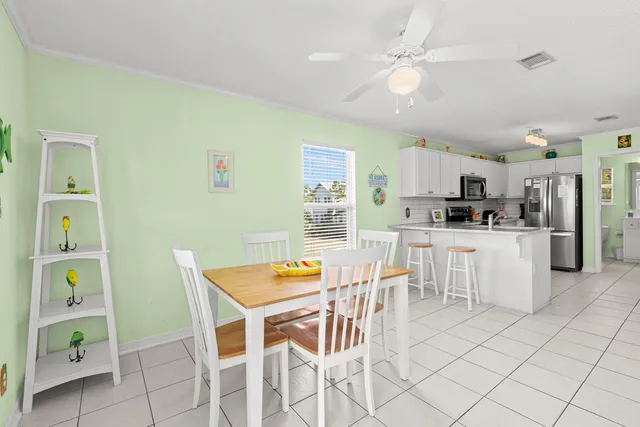 a kitchen with cabinets and chairs