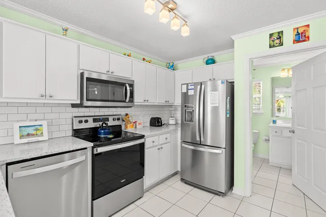 a kitchen with a refrigerator stove and sink