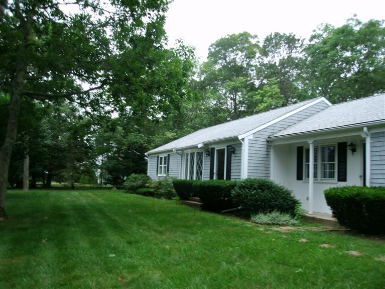 a view of a house with backyard sitting area and garden