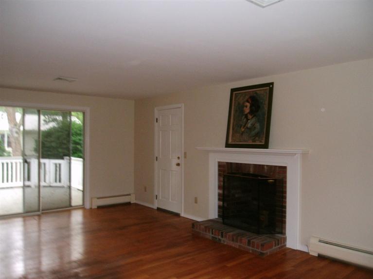 23 Ansel Howland Road Centerville, MA 02632 - Photo 13 of 27 a view of a livingroom with wooden floor and a fireplace