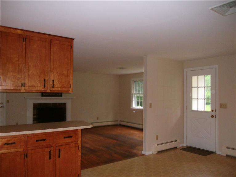 23 Ansel Howland Road Centerville, MA 02632 - Photo 16 of 27 an empty room with wooden floor and windows