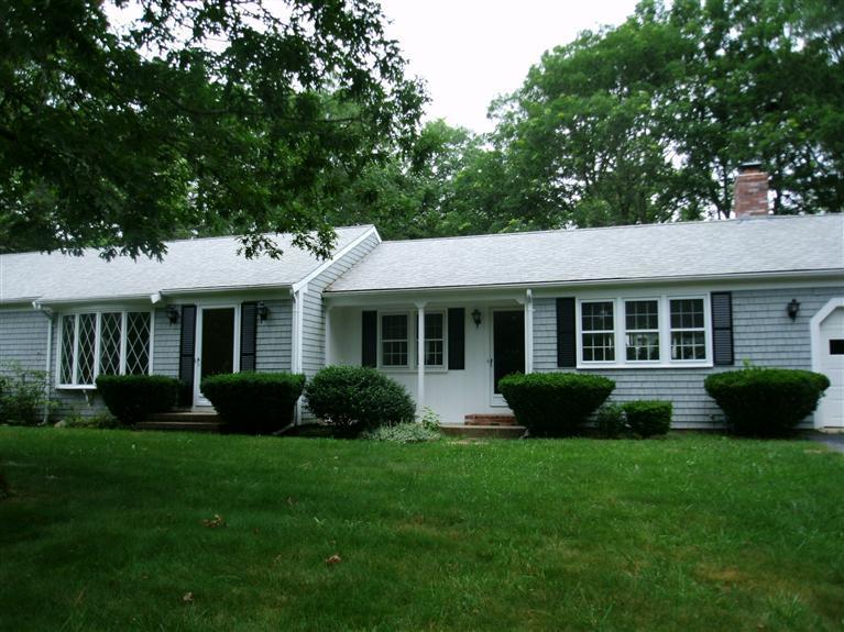 23 Ansel Howland Road Centerville, MA 02632 - Photo 2 of 27 a front view of a house with a yard and porch
