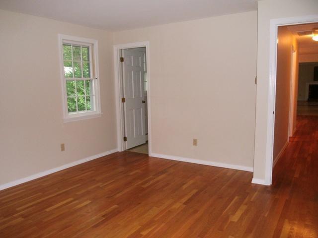 23 Ansel Howland Road Centerville, MA 02632 - Photo 23 of 27 an empty room with wooden floor and windows