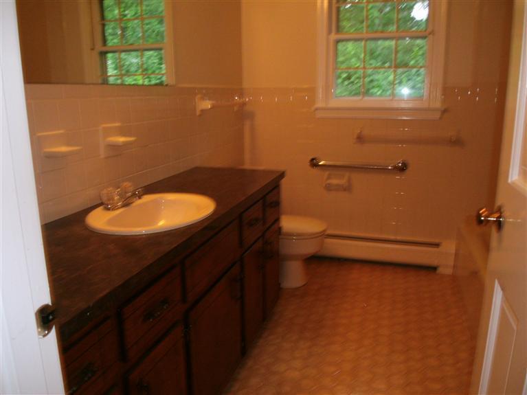 23 Ansel Howland Road Centerville, MA 02632 - Photo 27 of 27 a bathroom with a sink toilet and a window