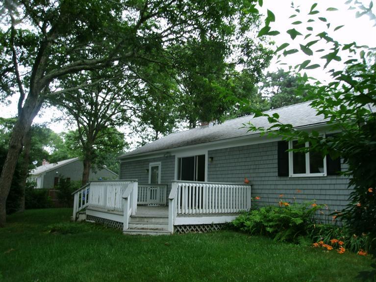 23 Ansel Howland Road Centerville, MA 02632 - Photo 9 of 27 a view of backyard with a deck and a large tree