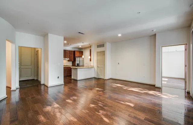 a view of a kitchen with a refrigerator and a sink