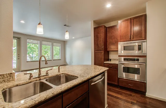 a bathroom with a sink vanity mirror and toilet