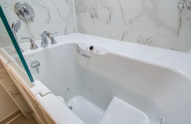 an empty room with closet and a ceiling fan