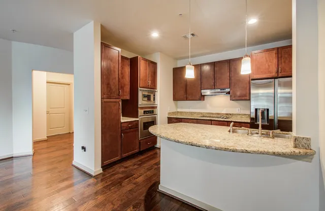 a kitchen with stainless steel appliances granite countertop a refrigerator and a sink