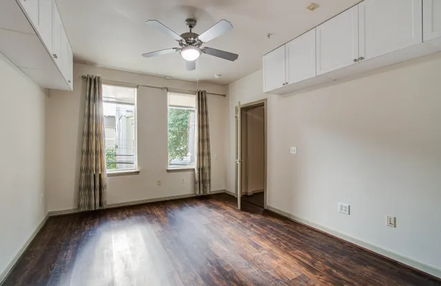 a bathroom with a granite countertop sink a mirror and a shower