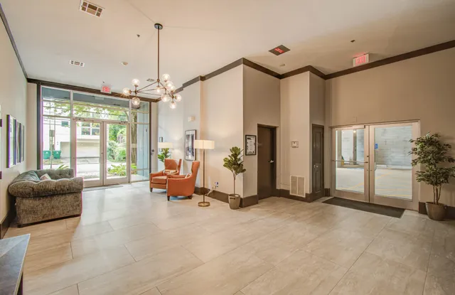 a living room with furniture and a chandelier