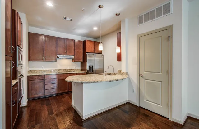 a kitchen with granite countertop a refrigerator and a stove