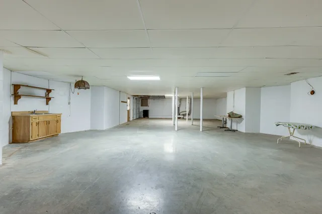 a view of a house with a big yard and large trees