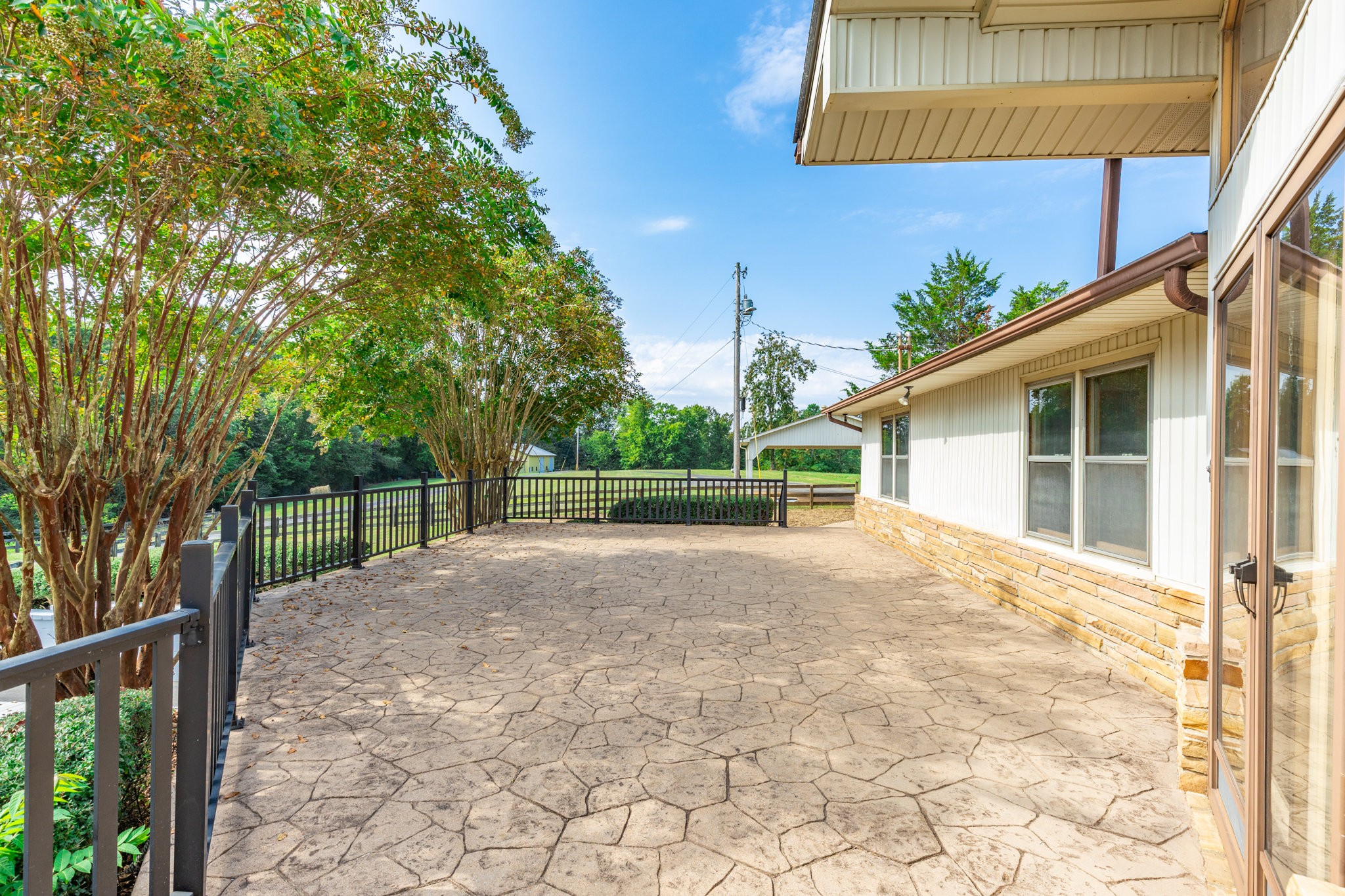 1340 Magazine Road Pulaski, TN 38478 - Photo 4 of 83 a view of a backyard with brick wall and a large tree