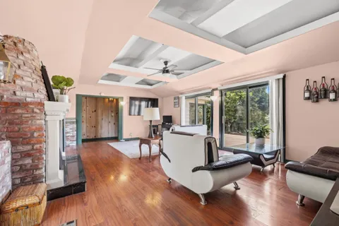a living room with fireplace furniture and a wooden floor